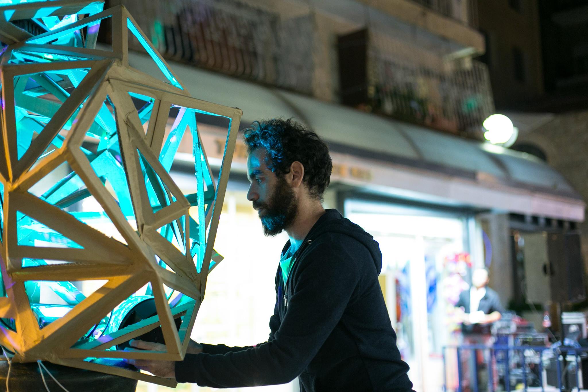 sculptor displays art piece in the street during Shaon Horef Jerusalem winter festival