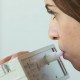 Woman breathing into device that can detect early stages of disease