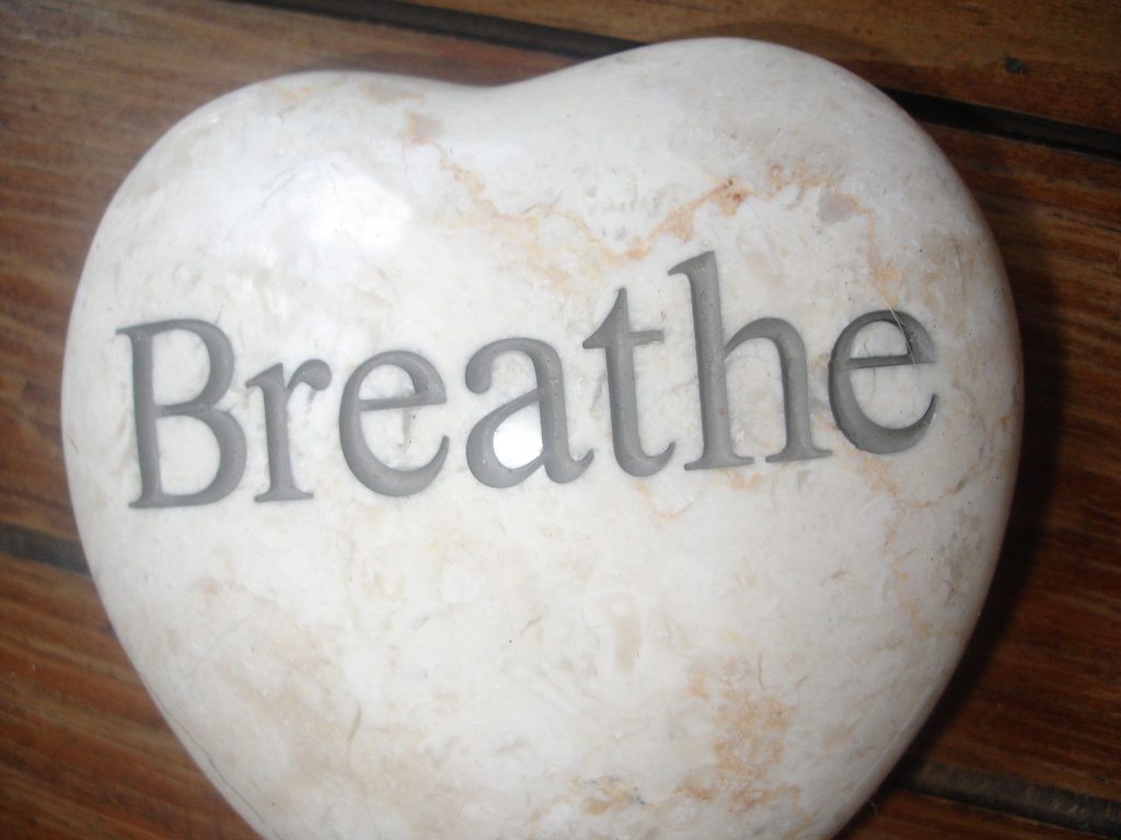 Heart-shaped rock engraved with the word "Breathe"