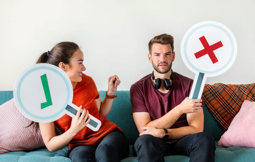 ken and lo in hebrew is yeas and no in english in the picture with signs held with x for no and a check mark for yes