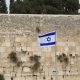 Israeli Flag in front of the Western Wall in the Old City of Jerusalem.
