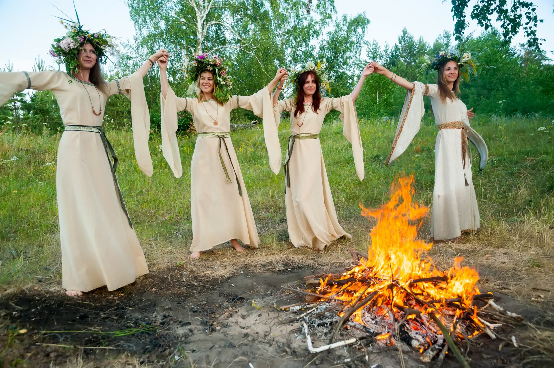 women dancing in white dresses in the forest around a bonfire like the women of tu bav who were dancing in the vineyard to look for a husband in tu bav 
