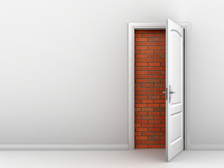 A door opened to a brick wall that simbolizes the inability of many people in the world who have no alternatives so the university of the people can help them get a new option to explore